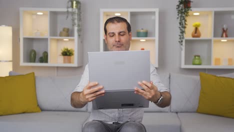 Man-joyfully-embracing-laptop.