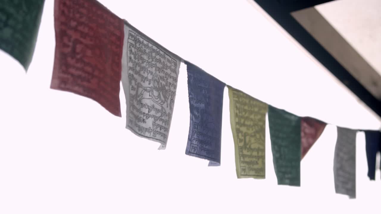 Colorful prayer flags flutter, symbolizing peace and spirituality