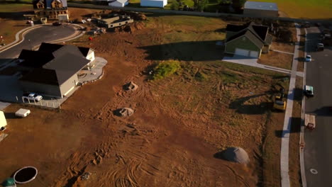 a drone shot spinning around an empty lot that awaits being dug up to start building a new home