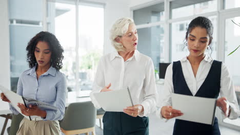 three businesswomen in office discussing project