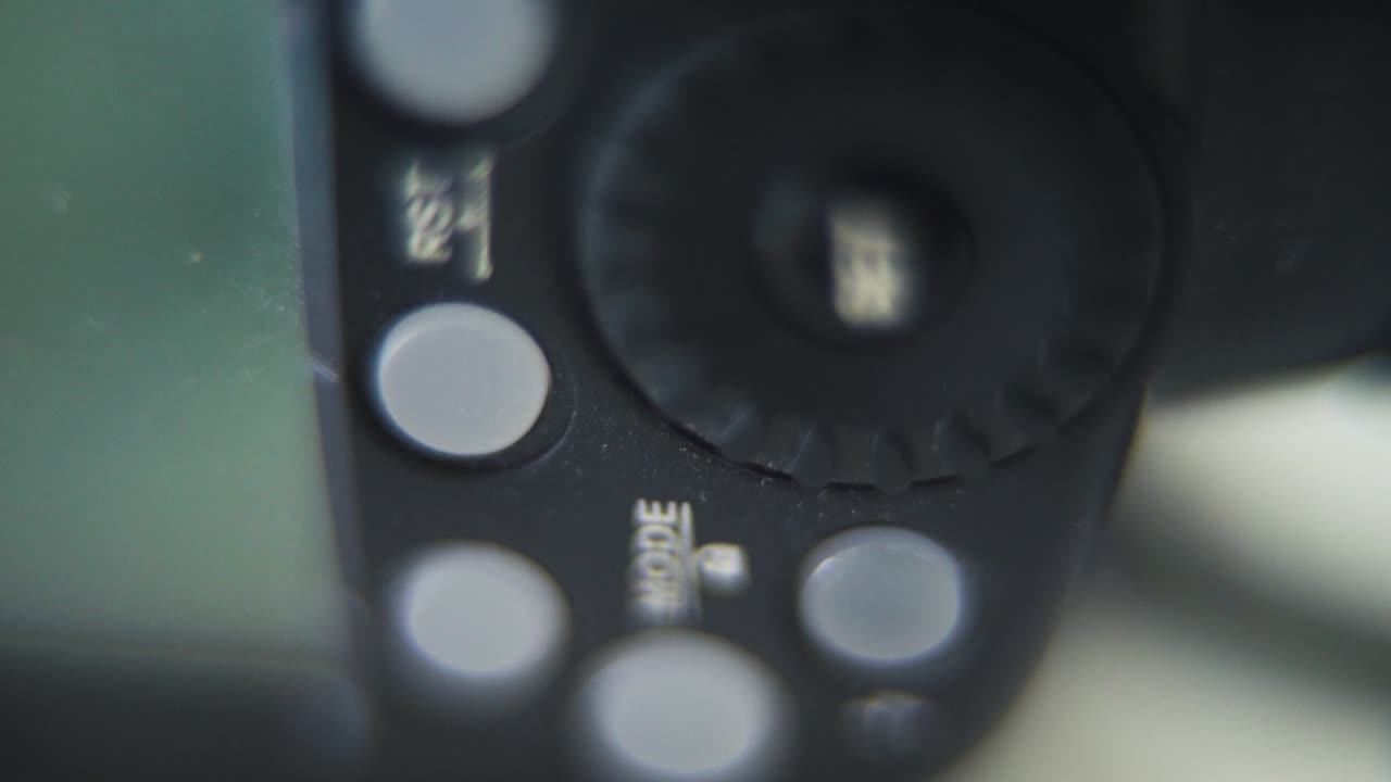 Macro vertical shot of a Speedlight, flash light, camera gear, buttons and screen, tilt up crane movement, slow motion 120fps, Full HD
