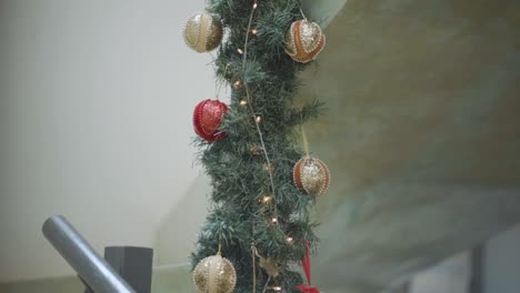 Christmas-Light-Decorations-Sparkling-on-Stairs,-Garland-Ornaments,-Close-Up,-Natural-Light