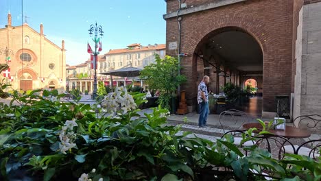 people walking near alba's historic architecture