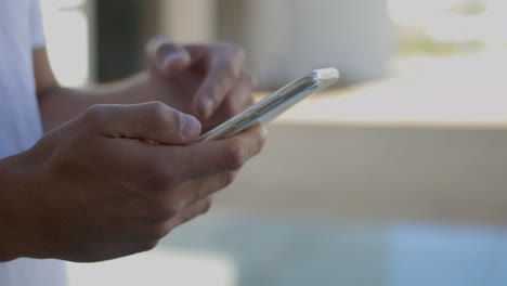 cropped shot of man using modern smartphone outdoor.