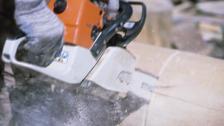 Chainsaw Cutting a Log