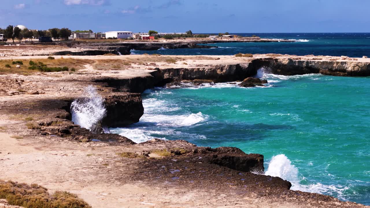 Sea waves splashing into rocky shore of Italy, aerial view