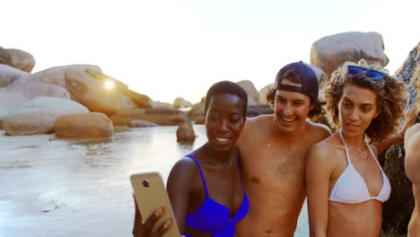 group of friends taking selfie with mobile phone 4k