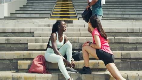 two motivated female athletes stretching