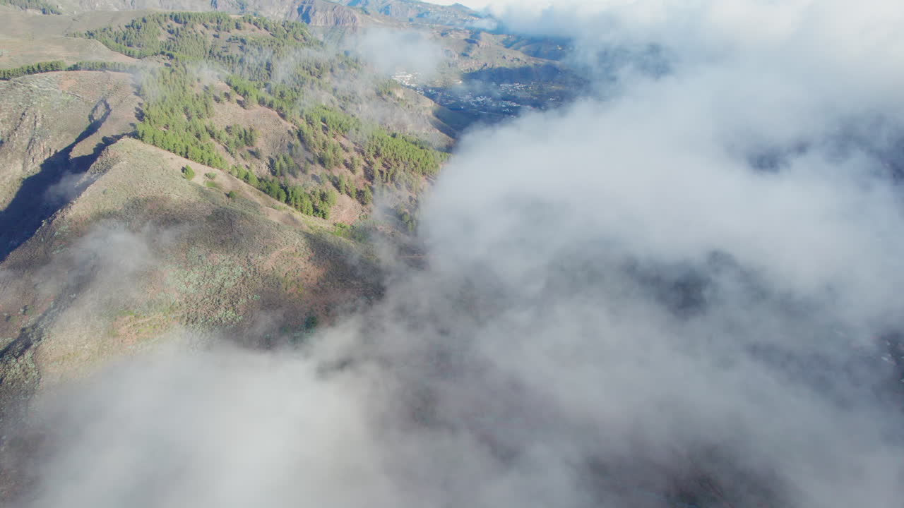 Aerial View of Cloud-Covered Mountain Landscape with Valley