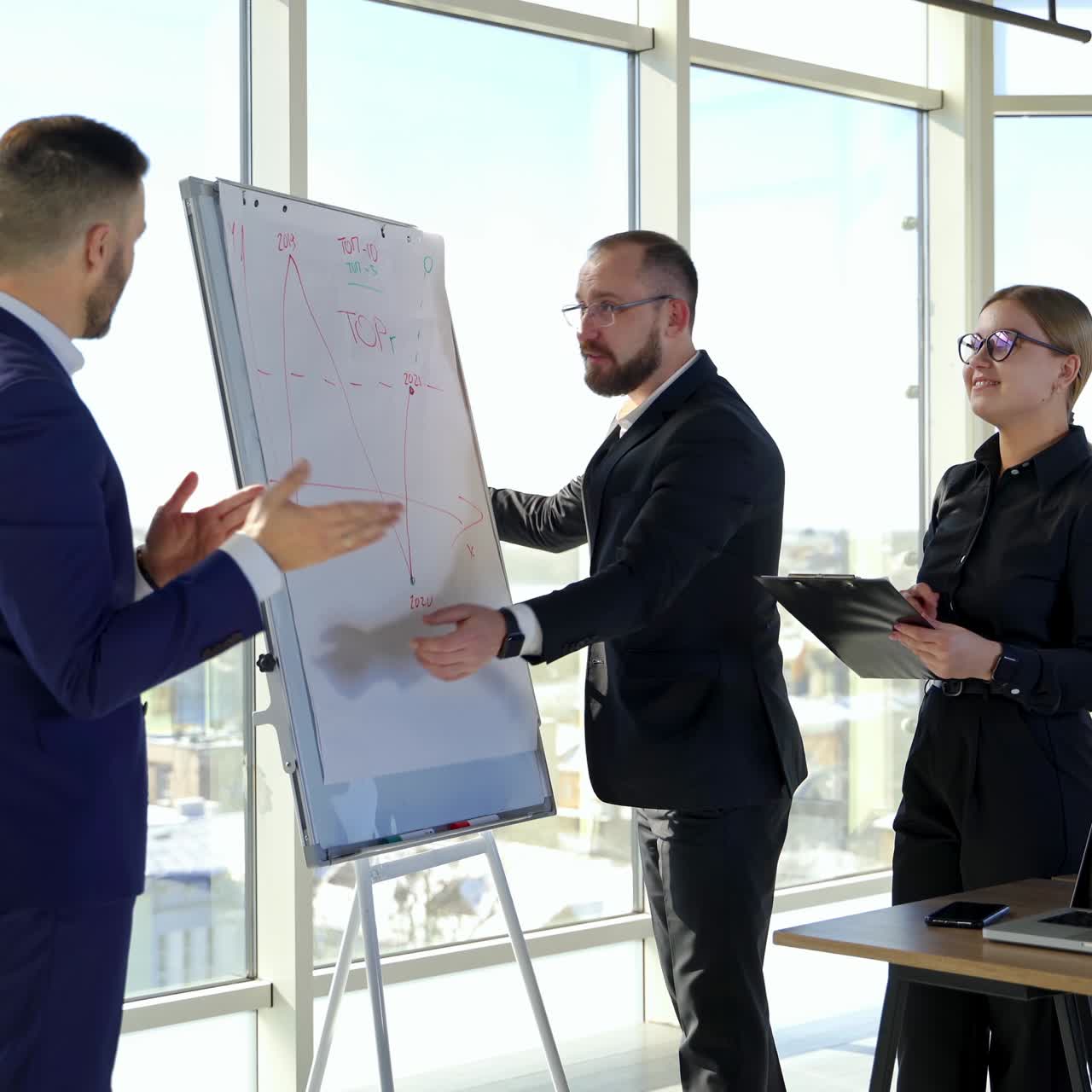 Happy business team discussing together at office meeting with laptop. Brainstorming at the office