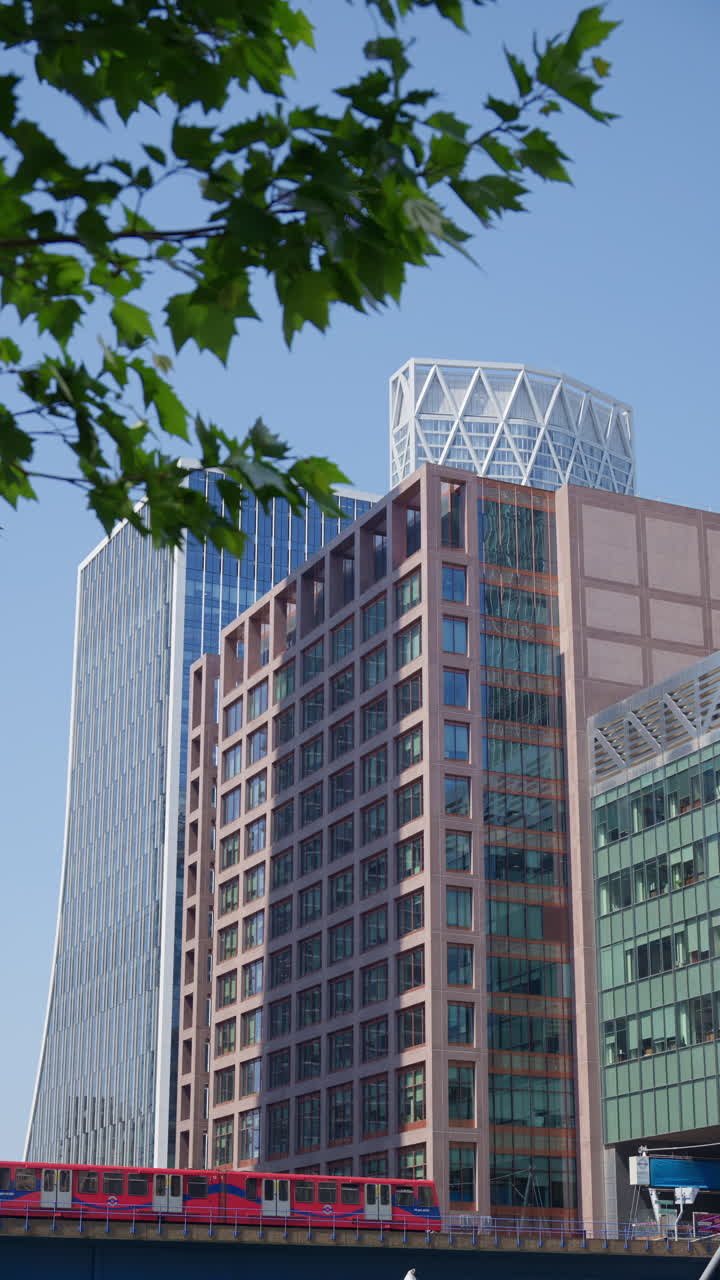 A Railway moving through Canary Wharf. Vertical, London, England
