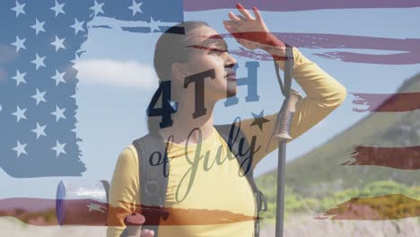 Animation-of-independence-day-text-over-biracial-woman-looking-away-in-mountains