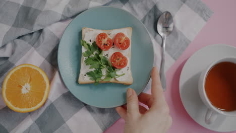 breakfast sandwich with orange and tea