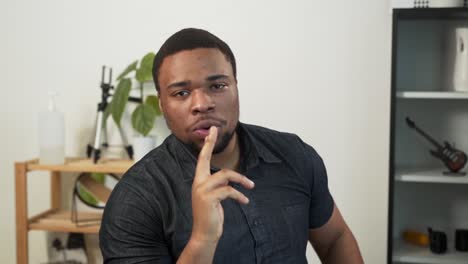 charismatic african man making fingers with a gun