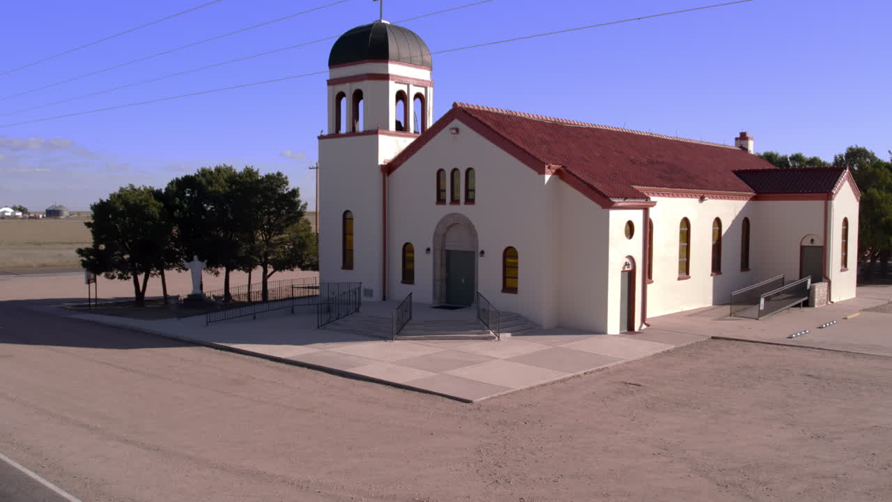 Reveal of Small Church at dirt road intersection in Countryside