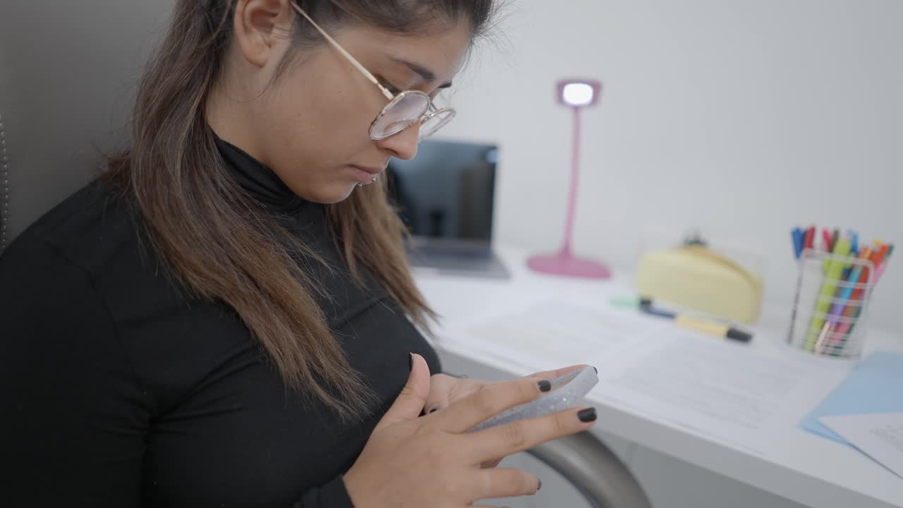 Woman using a smartphone in an office setting