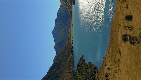 Vertical-orientation-flying-over-Moke-Lake-near-Queenstown,-New-Zealand