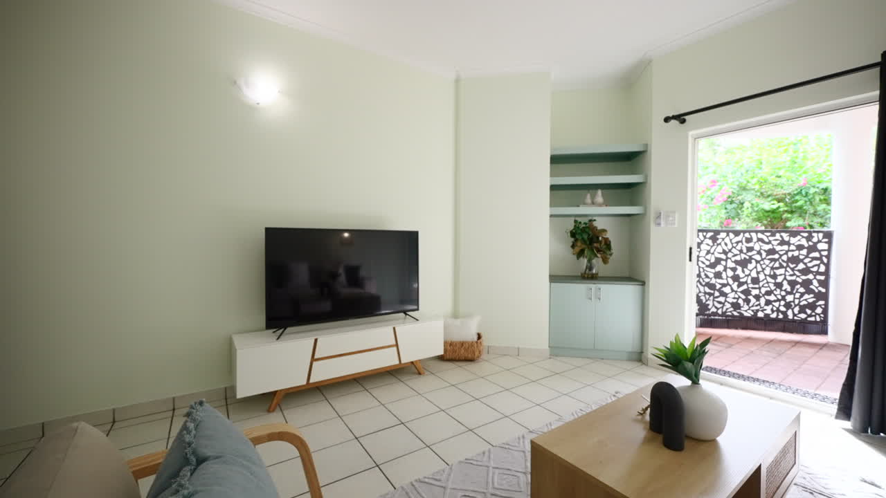 Pullback Above Wooden Veneer Chair and Coffee Table of Small Modern Tiled Apartment Loungeroom, Sliding Door to Balcony Outside