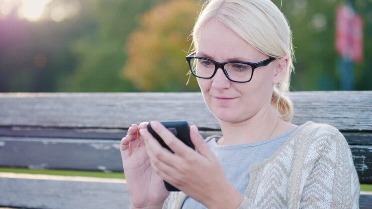Woman Using Smartphone on a Bench