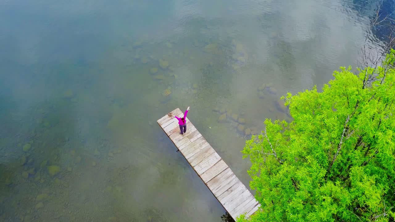 Person on a Wooden Dock Over a Lake