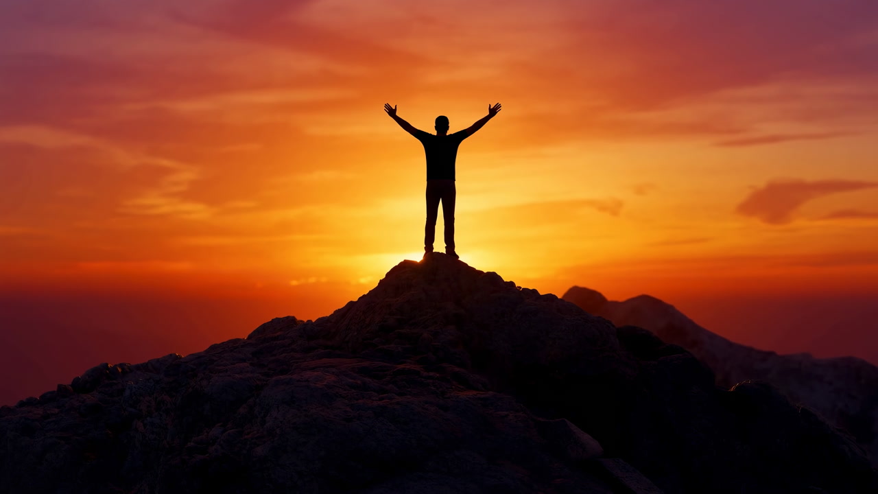 Silhouette Hiker On Mountain Sunrise With Arms Raised Against Dramatic Orange Sky, Rocky Peak Foreground,