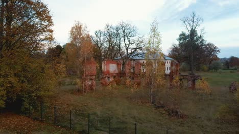 aerial view of the ruins of an ancient manor in golden autumn
