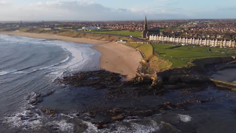 drone circling round caves and rocks at north of tynemouth longsands beach
