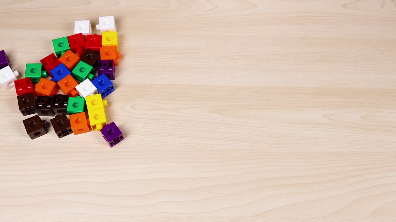 Hands organizing cubes on a wooden surface