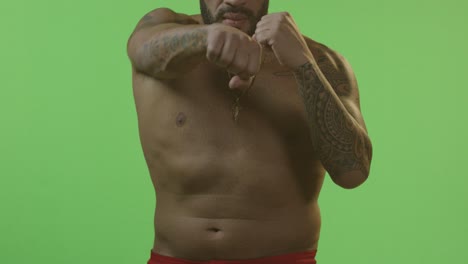 man in boxing stance on green screen