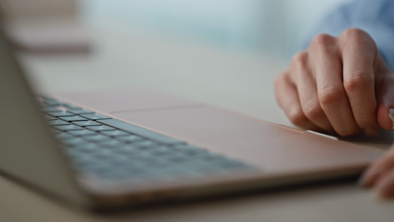 Woman fingers tapping touchpad laptop in office closeup. Unknown businesswoman