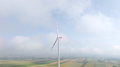 wind turbine in the weinviertel region on a foggy day in austria - aerial drone shot
