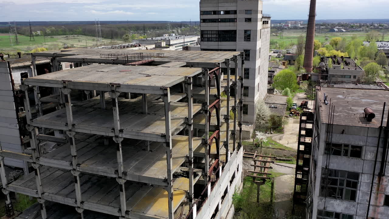 Destroyed buildings. Abandoned territory of an old industrial plant. Ancient factory with ruined buildings. Aerial flight.