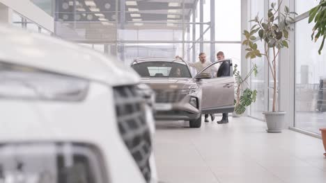 car dealership with row of anonymous new vehicle on sale. showroom with shiny auto. automotive