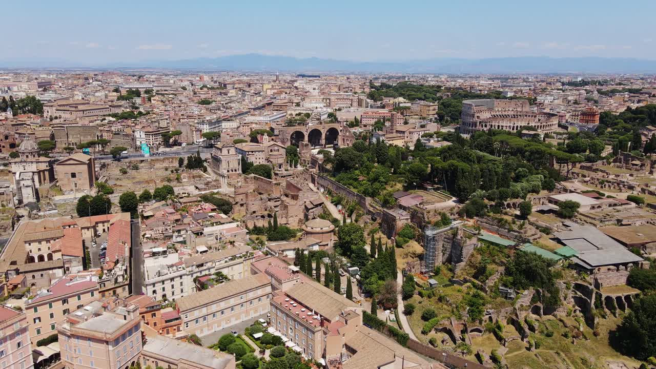 Drone flies above ancient ruins and Colosseum in the sunny heart of Rome, Italy