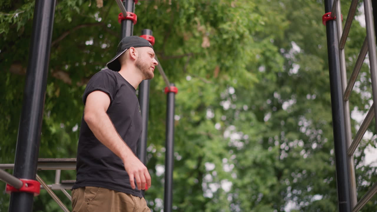 Dynamic Scene Of Person Kicking High Near Bars Amid Lively Background, An Energetic Individual Demonstrates Explosive Movement Against Wooded Setting Filled With Cheerful Atmosphere