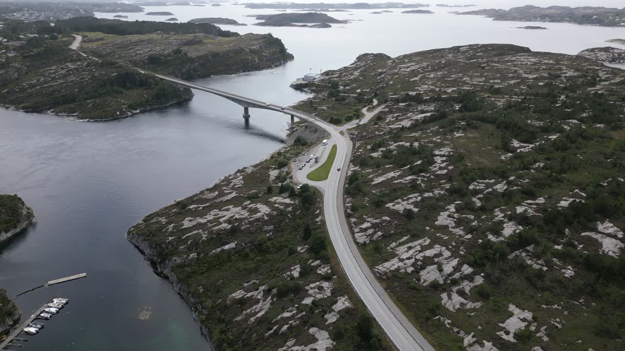 Cars Driving on Road in &Oslash;ygarden, Norway near Bergen with Beautiful Landscape and Cars driving over Svelgen Bridge