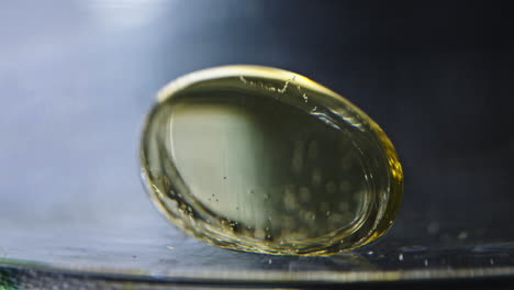 pill dissolving in liquid, close-up shot of the pill slowly dissolving in the liquid