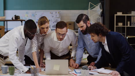 multiethnic business team analyzing documents, charts, financial reports and graphics in the office