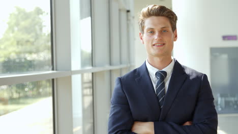 Portrait-Of-Businessman-Walking-Towards-Camera-And-Smiling