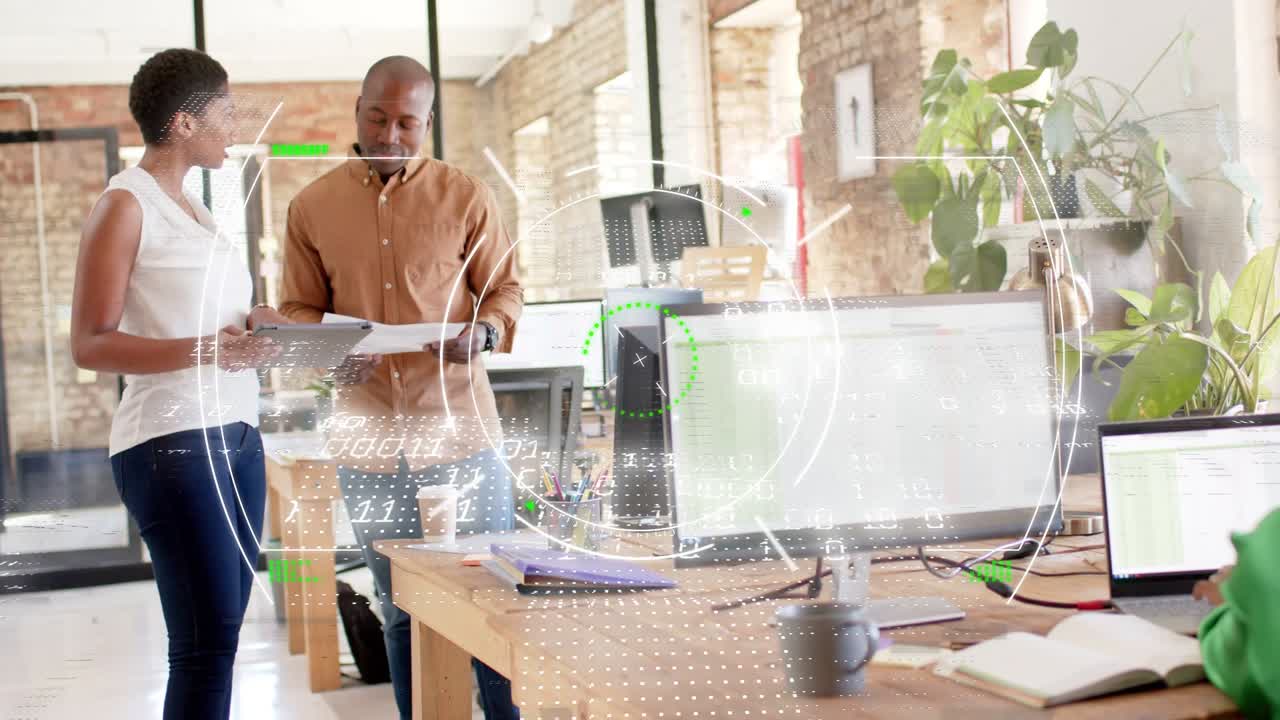 Woman tilting tablet, man holding papers, reviewing business documents while HUD overlay expanding