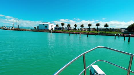 Witness-the-graceful-departure-of-a-boat-from-the-bustling-harbour,-a-captivating-maritime-scene-that-embodies-the-allure-and-tranquillity-of-coastal-life