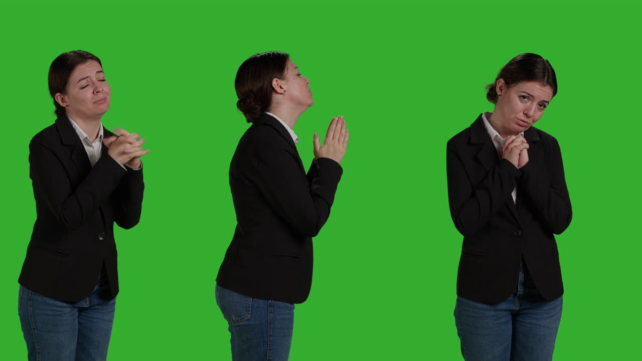 Businesswoman praying on green screen