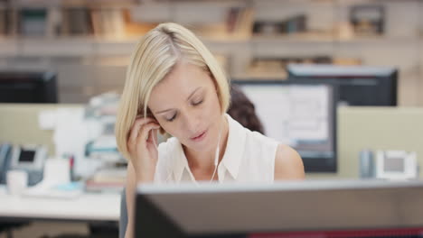 powerful businesswoman executive working at computer using smart phone connected to global data in busy corporate office