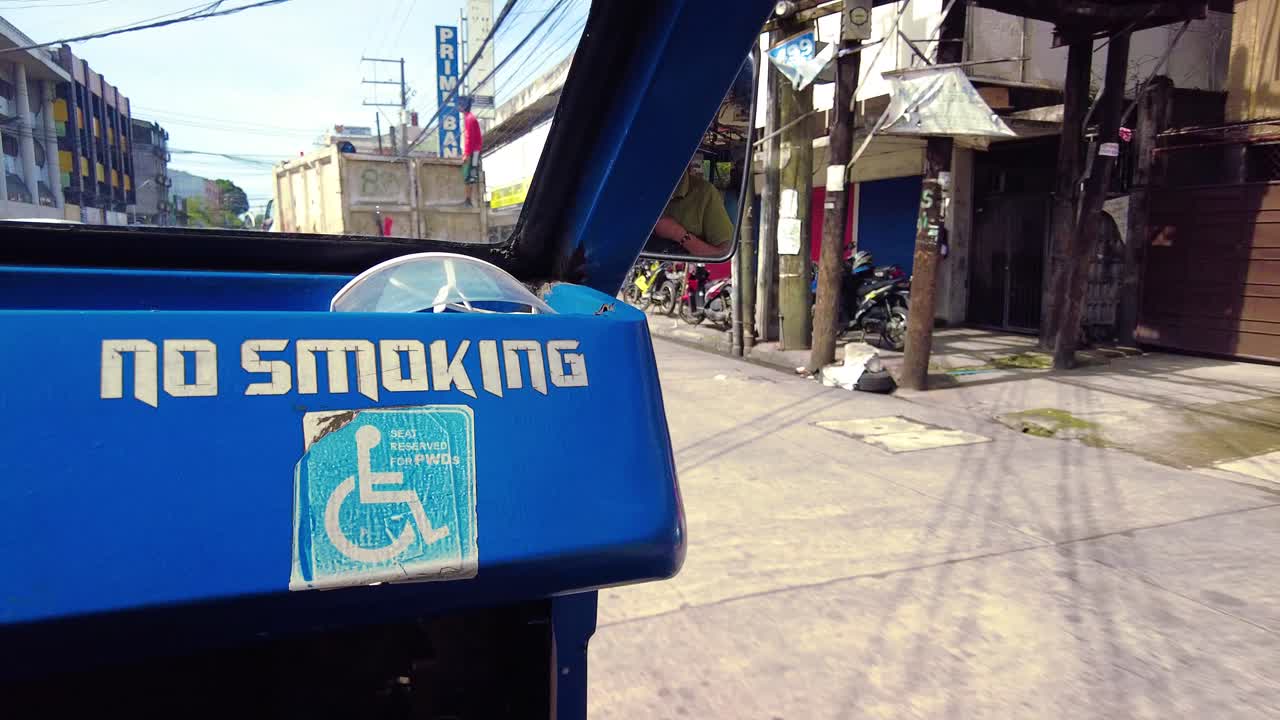 A passenger-sire ride on a Jeepney for public transportation. They are known for their crowded seating and kitsch decorations, which have become a widespread symbol of Philippine culture and art.