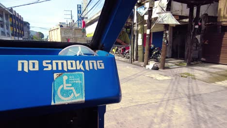 a passenger-sire ride on a jeepney for public transportation. they are known for their crowded seating and kitsch decorations, which have become a widespread symbol of philippine culture and art.