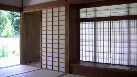 pan from shoin desk and interior of japanese house to view of pond and garden