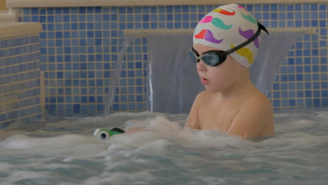 Child-getting-hydromassage-in-pool