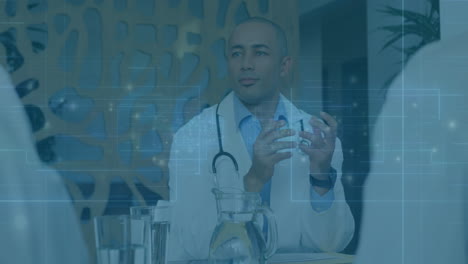 male doctor gesturing in medical office, displaying digital data overlays and wearing stethoscope