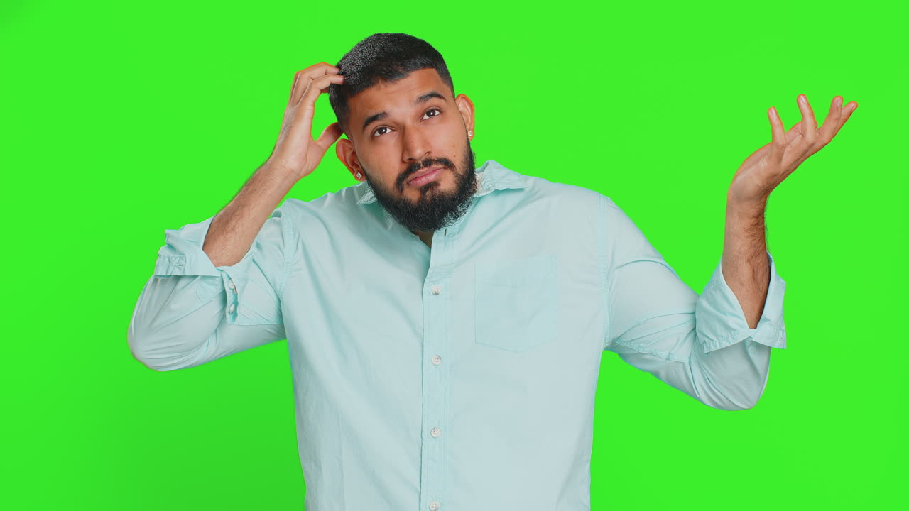 Confused indian man feeling embarrassed about question having doubts no answer clueless uncertain