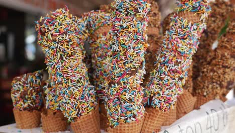 colorful chocolate-covered ice cream cones with sprinkles